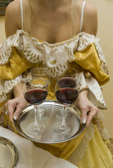 glasses filled with red wine on a beautiful tray.