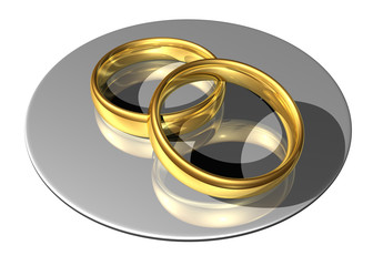 golden wedding rings on a reflecting plate