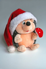 a toy hedgehog decorated for christmas.