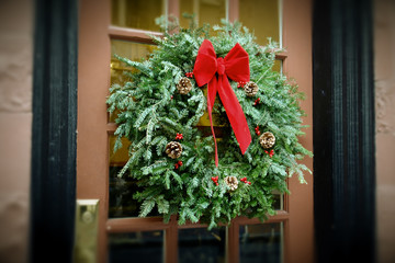 antiqued christmas wreath hanging on door