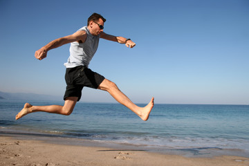 man jumping on the beach