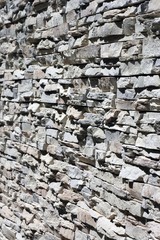stony wall closeup in the sunshine - shallow dof