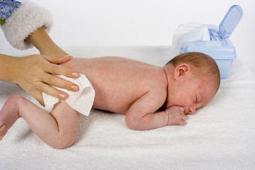 mother cleaning baby's skin
