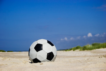 soccer ball on sandy beach