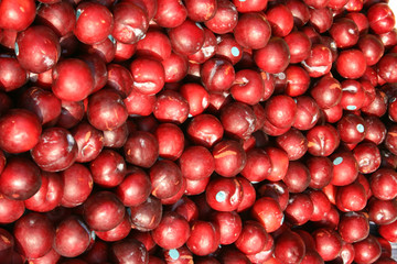 red plums at a market stall