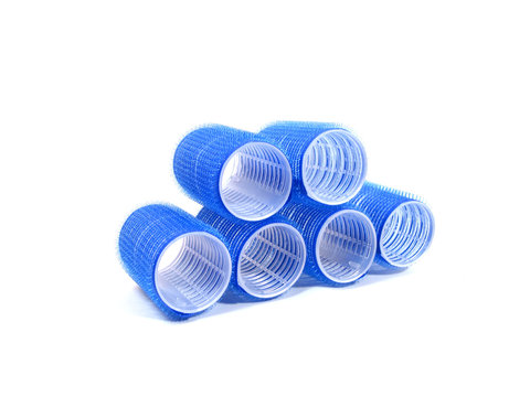 six blue hair curlers over white background