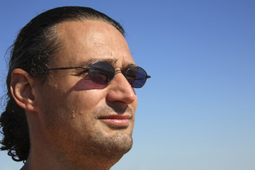 portrait of a man with sunglasses (blue sky)