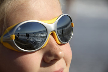 girl with sunglasses (reflecting the beach)