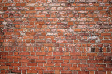 a grungy red brick wall texture / background
