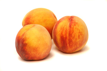 Fototapeta na wymiar three peaches on white background