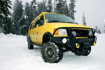 yellow van on snow road