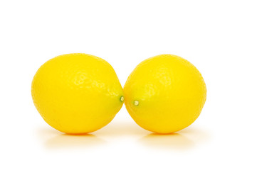 two yellow lemons isolated on the white