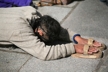 worshipping pilgrim in lhasa (tibet)