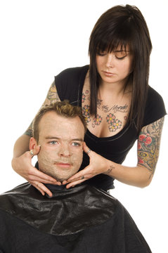 spa esthetician applying facial masque to man