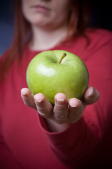 woman holding fresh apple