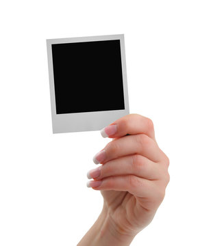 hand with polaroid frame