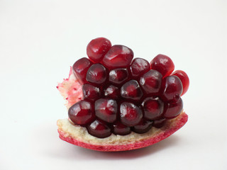 pomegranate seeds in macro on white