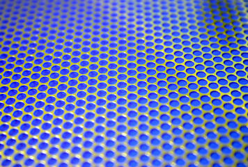 gold grid with shallow focus on a blue background.