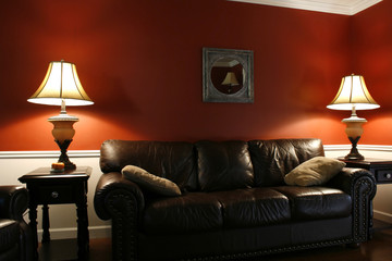 inside the living room with a couch and lamps