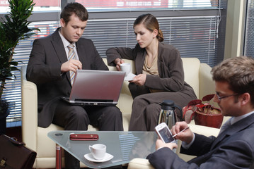 men and woman in an office - working with latop an