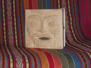book with imprinted face on peruvian textile