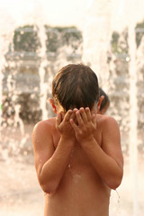 boy in water fountain
