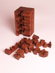 wooden puzzle in walnut with missing pieces