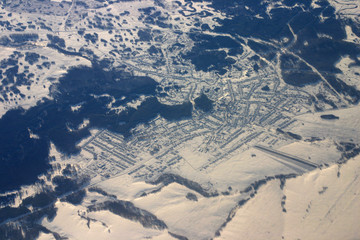 aerial view of small town covered by snow