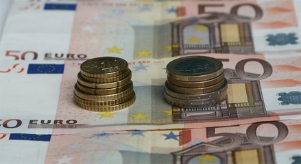 euro coins on top of euro banknotes
