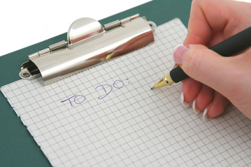 female hand writing to do list