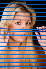 glamour shot, peeking from behind blinds