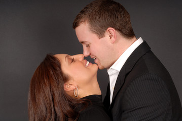 attractive young couple in each others arms staring at each othe