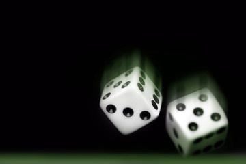 rolling two dices on black background