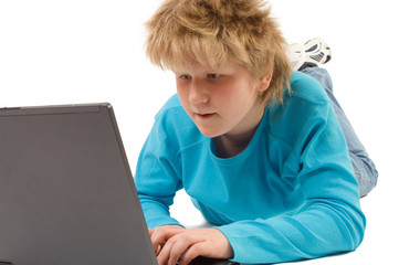 blonde boy working with laptop