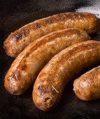 sausages in a black frying pan