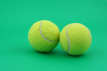 two tennis balls on green