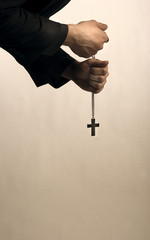 Priest's hands with cross