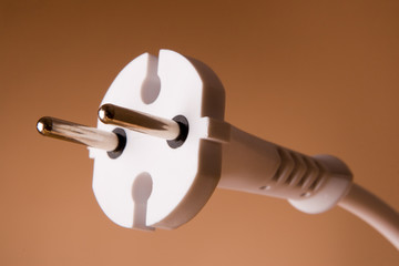 two pins electric plug on the beige background