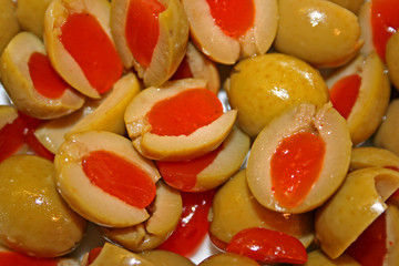 Green olives cut in halves and stuffed with red pimento, a classic Mediterranean snack.