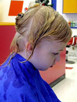 Girl At The Beauty Shop With A Blue Smock