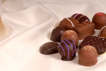 pieces of semi-sweet and bittersweet chocolate on beige satin