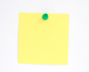 post-it note pinned to white paper wall