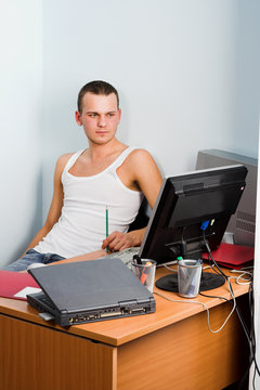 Young Businessman Works On A Laptop Computer In The Modern Offic