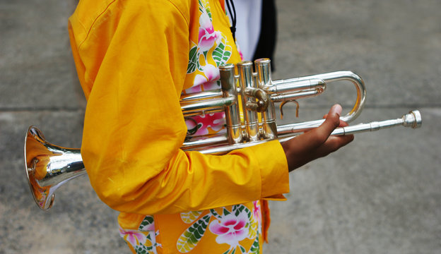 close-up of a band member holding a trumpet