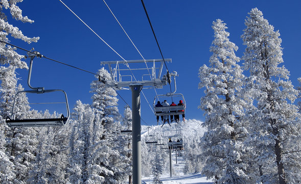 Riding A Lift On A Ski Resort.