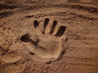big handprint in sand