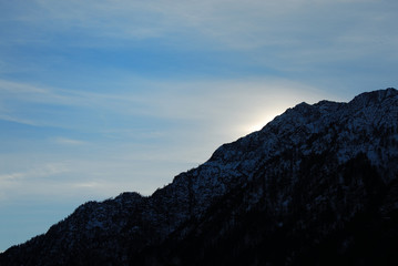 Fototapeta na wymiar sun behind the mountain