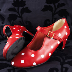 two red flamenco dancing shoes with white dots