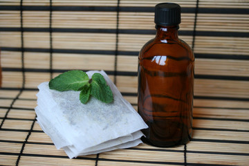 bottle with tea bags and mint leaf