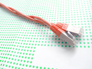 red ethernet cable on green dotted backgroud